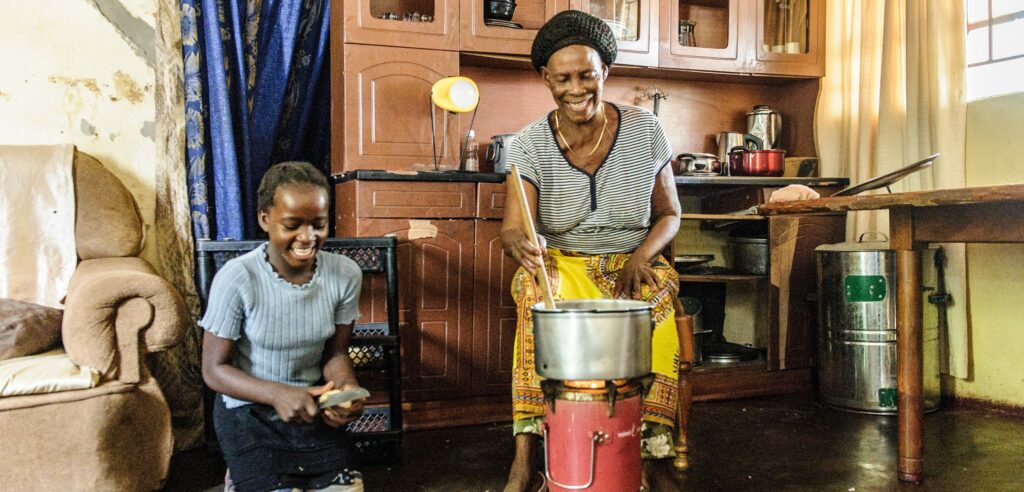 Clean cooking in Zambia - Girl and grandma - Photo: Jason Mulikita