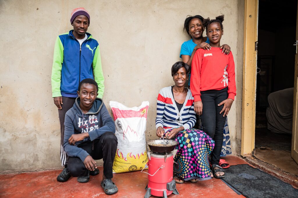 Family using a modern cooking stove that works with pellets