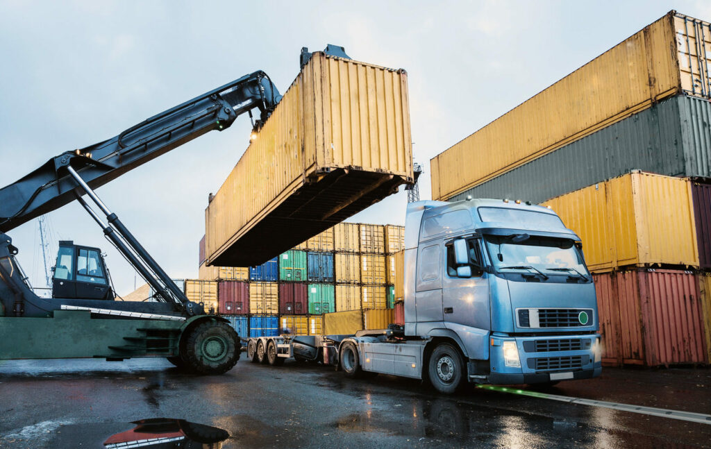 Electric truck charging its battery on an electric road system while changing the cargo