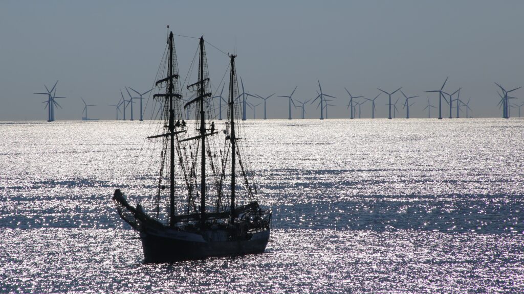 Sailing ship in front of a modern offshore wind park in Denmark. Photo: Unsplash