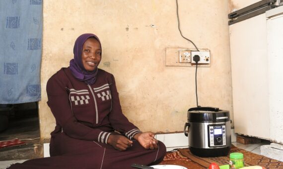 Photo: Female customer using a PowerUp e-cooker – UpEnergy Group