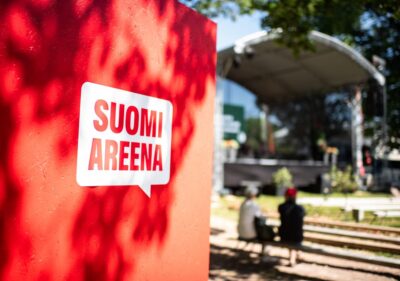 SuomiAreena logo with a stage in the background