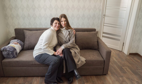 Olena with daughter, IDP living in the renovated urgent housing apartment building in Zvyahel.